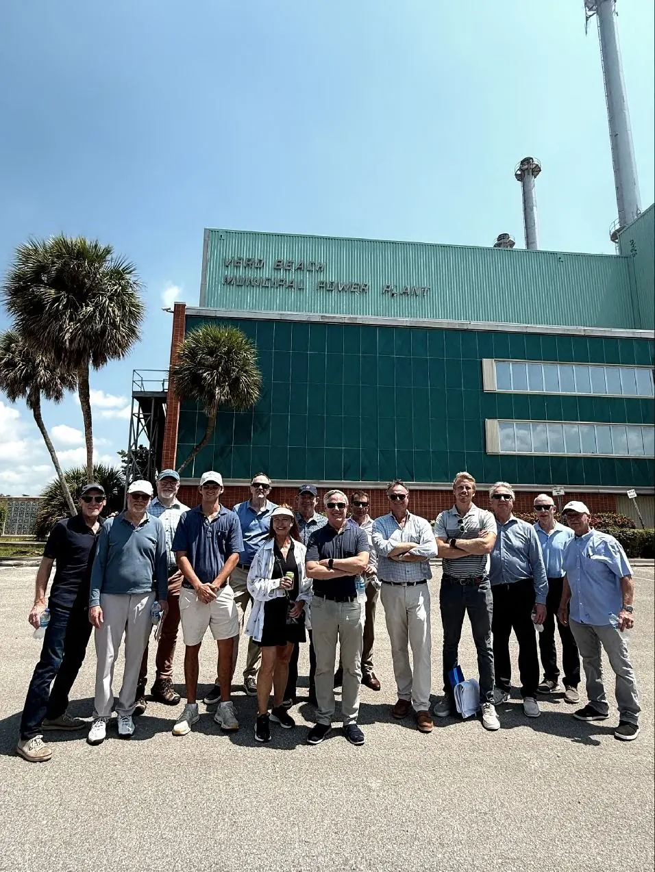 The Three Corners team standing in front of the Vero Beach Municipal Power Plant